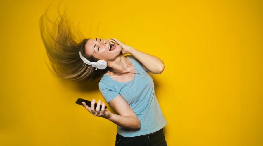 photography of woman listening to music