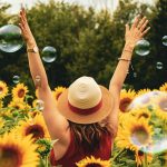 woman surrounded by sunflowers