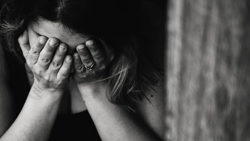 grayscale photography of crying woman