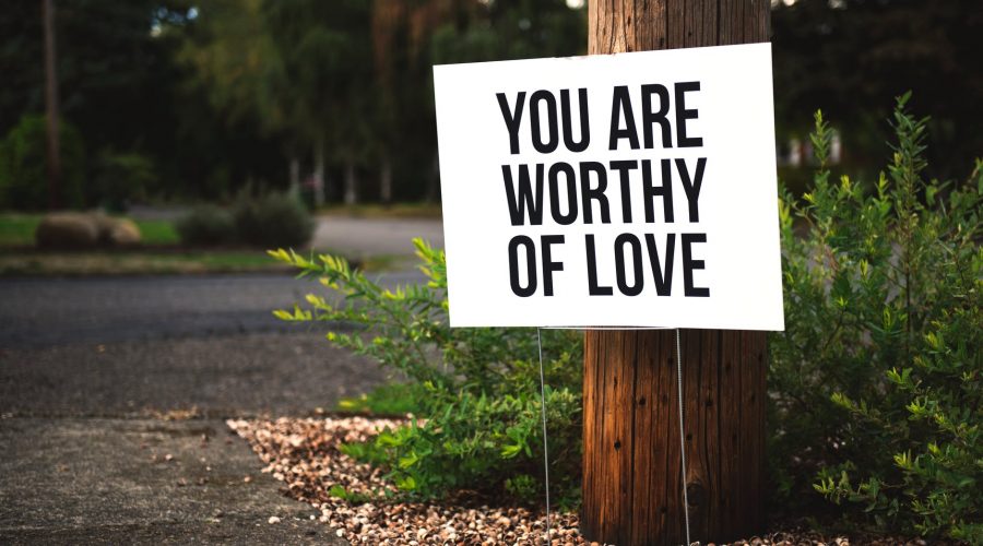 you are worthy of love signage on brown wooden post taken