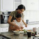 mother and daughter preparing avocado toast