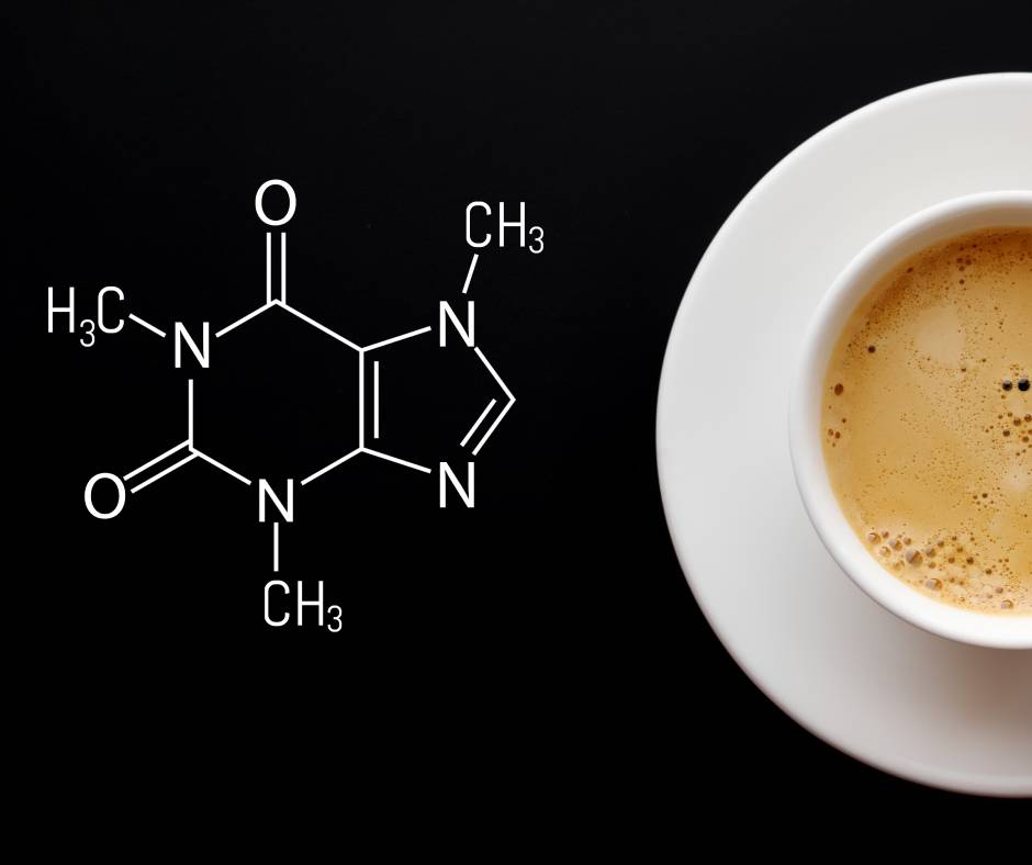 A cup of coffee on a plate that is next to a written formula for anhydrous caffeine. The plate and cup are white.